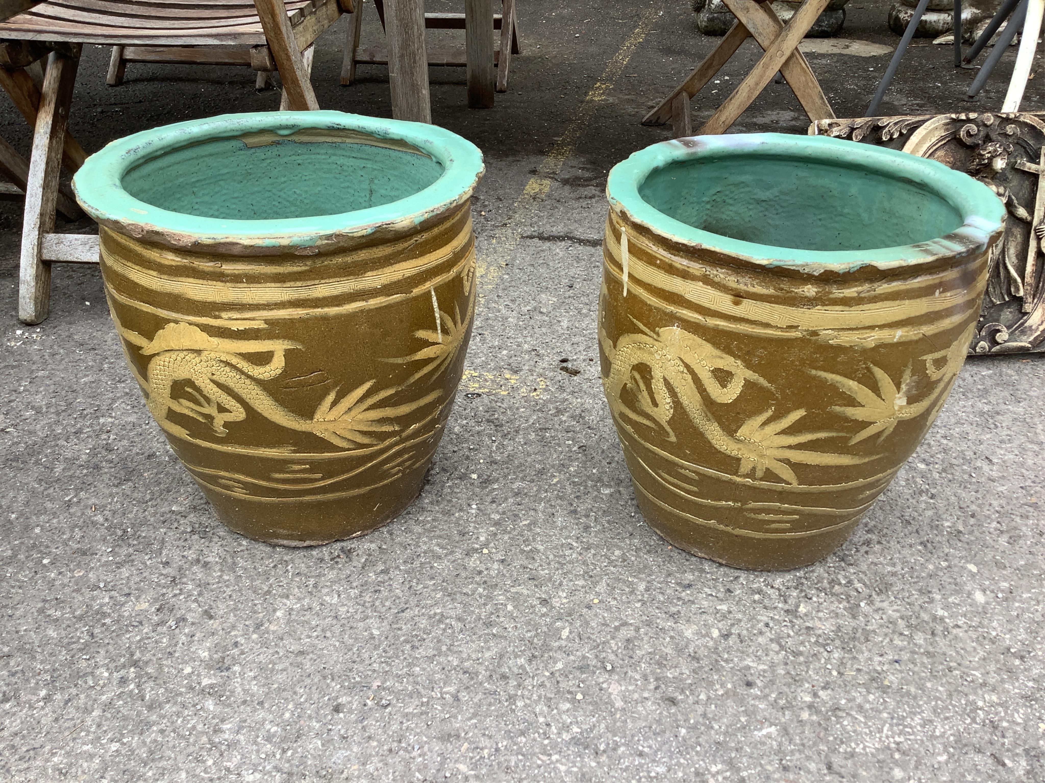A pair of Chinese style circular earthenware garden planters, diameter 36cm, height 39cm